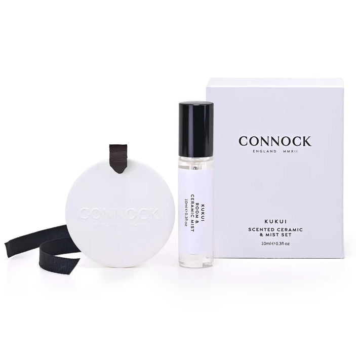 Connock Kukui scented ceramic disc diffuser and bottle of perfume on a white background