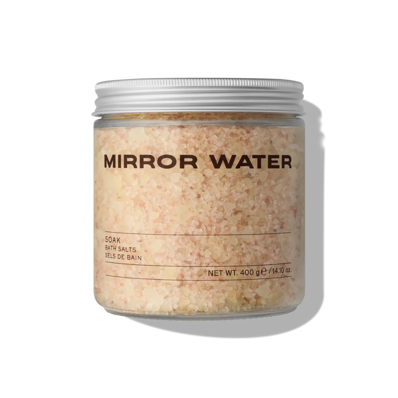 Jar of 'Mirror Water' bath salts that are slightly pink on a white background