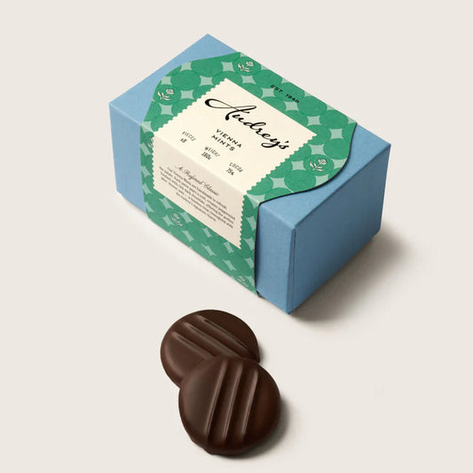 Chocolate mint creams with a decorative box on a light background