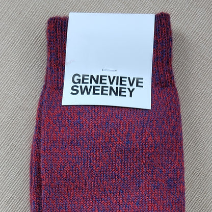 A close up image of socks and label showing the socks are a mix of red and blue yarns