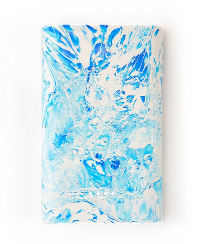 Block with rounded sides with blue and white marbled pattern on a white background