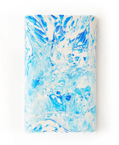 Block with rounded sides with blue and white marbled pattern on a white background