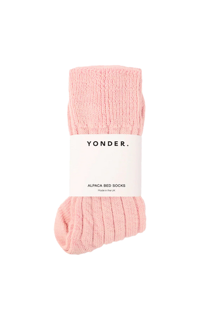 Pink alpaca bed socks with a 'Yonder' label on a white background