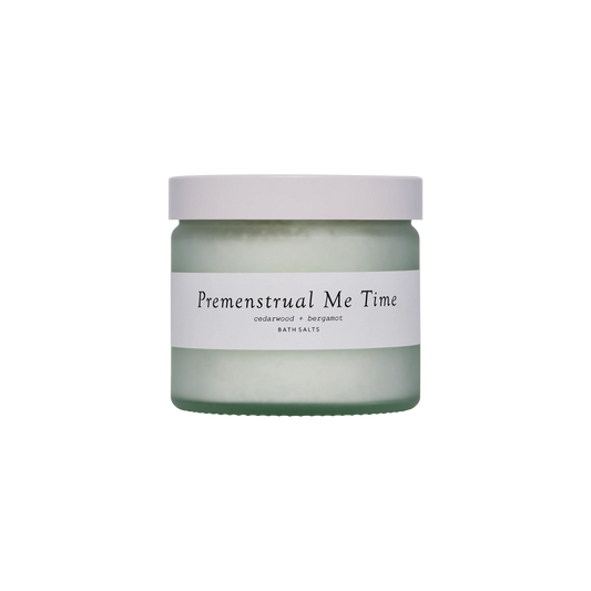 A glass jar with a white lid and a label saying Premenstrual Me Time