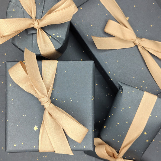 Blue grey gift boxes with gold ribbons on a matching background