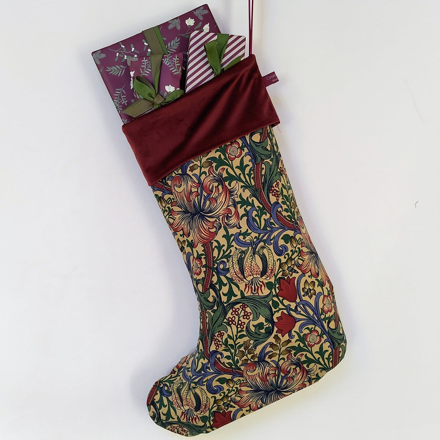 A Stocking made from a William Morris fabric filled with wrapped presents