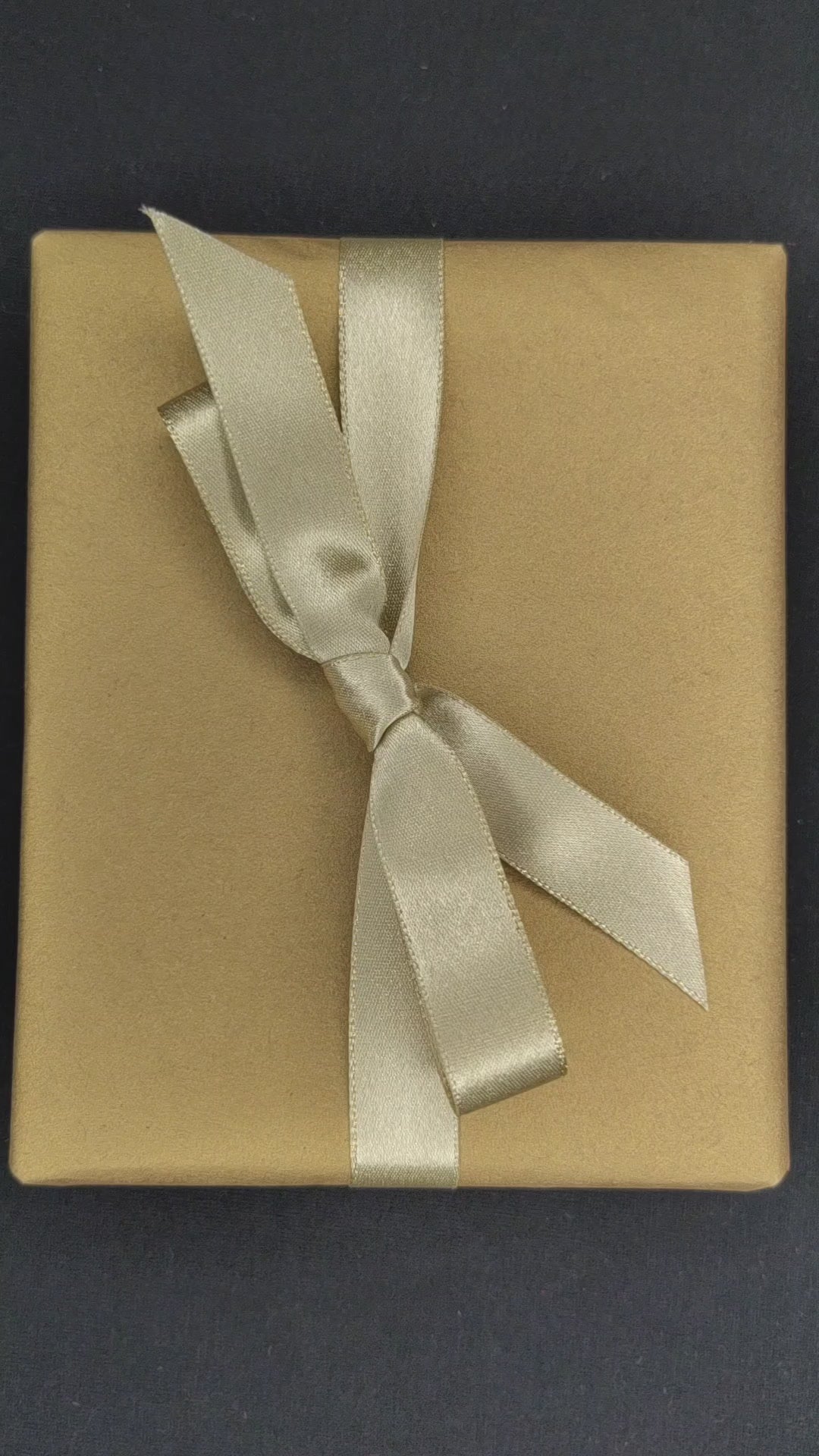 Video footage of someone unwrapping a GOMI power bank and then the footage is reversed and it is re-wrapped.